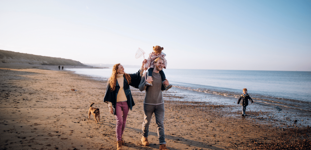 Picture of healthy family walking on the beach