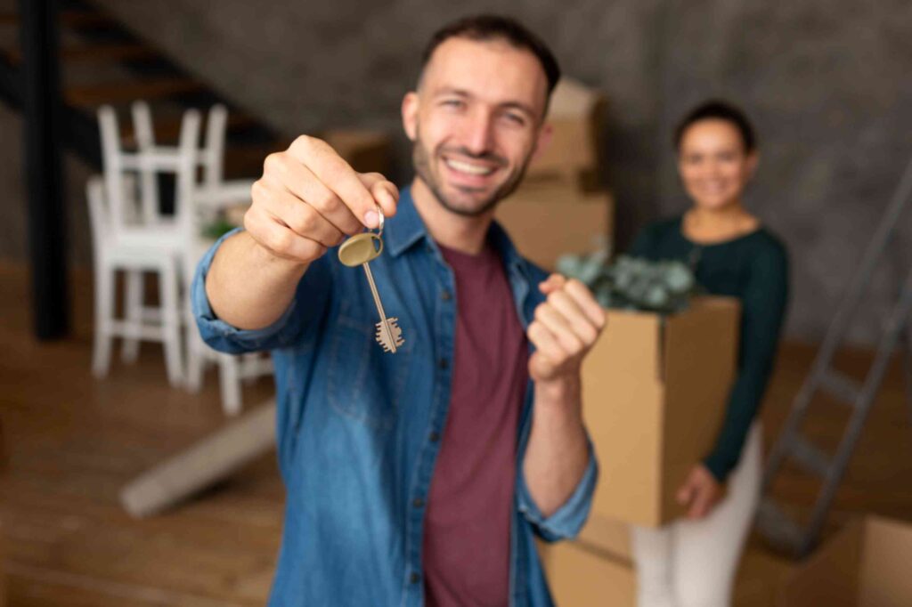 Young couple receiving keys to their first home in New Zealand
