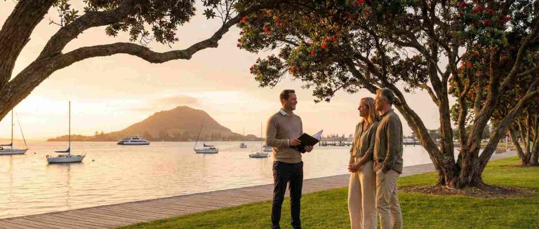 Mortgage broker explaining how home loans work to Tauranga buyers at the waterfront